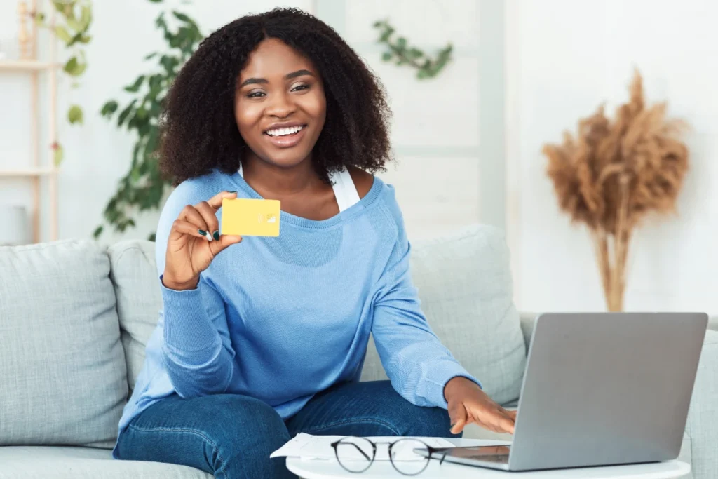 Young woman holding a credit card, symbolizing empowerment through our free DIY credit repair software.