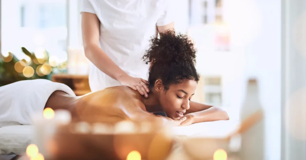 Woman receiving a massage as part of prioritizing self-care and living self-full.